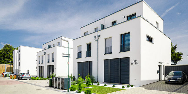 Modern semi-detached houses with well-tended front gardens, parking spaces and garages