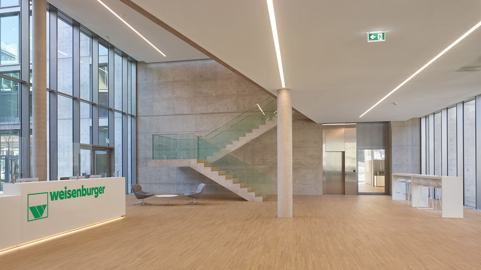 Foyer with cantilevered concrete staircase in the weisenburger headquarters in Karlsruhe