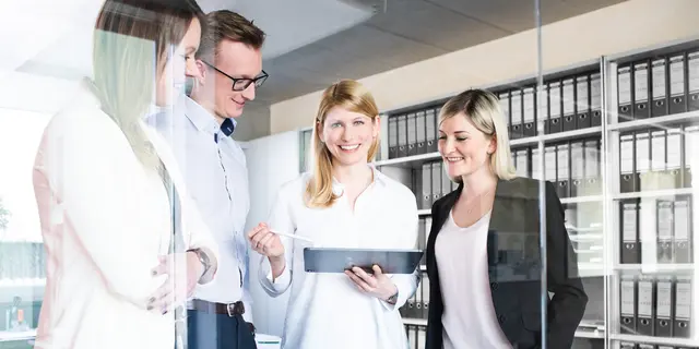 Project development team Employees looking at a tablet