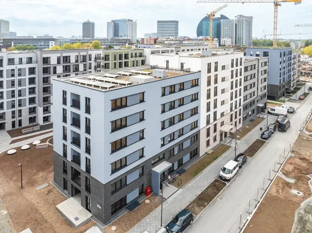 Apartment buildings from the weisenburger group in Frankfurt: modern architecture with light facades and dark accents. Inviting living atmosphere.