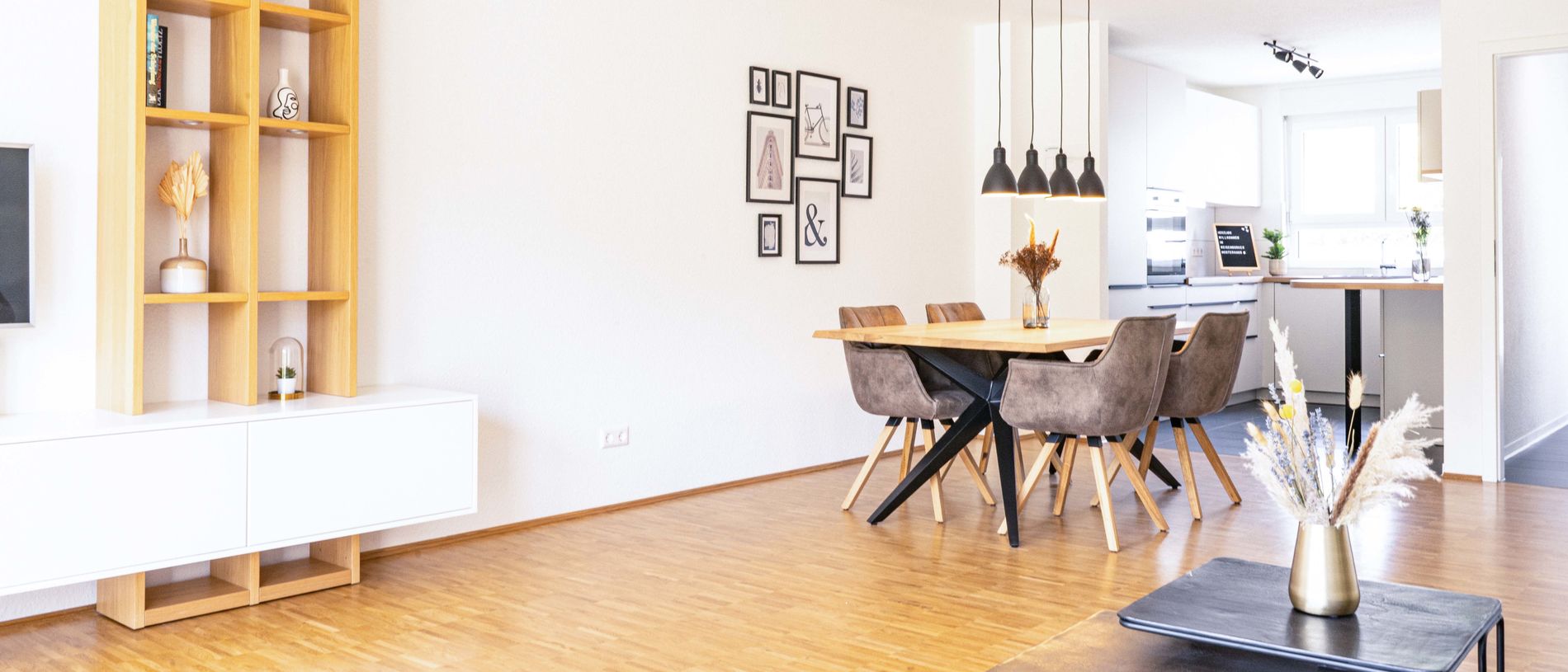 Glance into a bright dining room with parquet and modern furniture