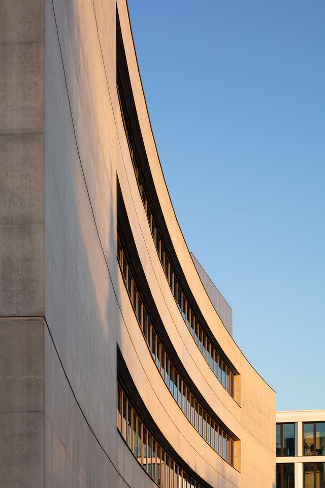 Curved north side of the building with a blue sky.