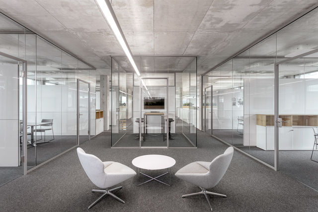  Looking down the hall: a low table with two chairs, a think tank and offices on both sides.