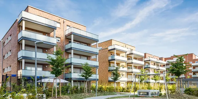 Projektentwicklung Wohnungsbau Mehrfamilienhäuser in Backsteinoptik mit Balkonen und Grünflächen