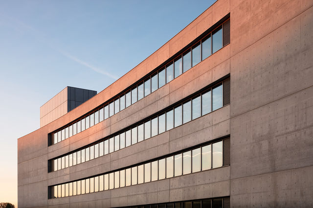 curved exposed concrete facade on the north side of the building