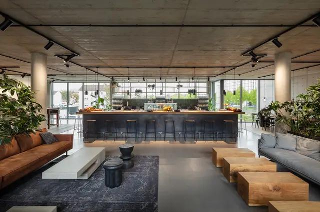 Counter and kitchenette in the cafeteria at the weisenburger headquarters with seating and lots of plants
