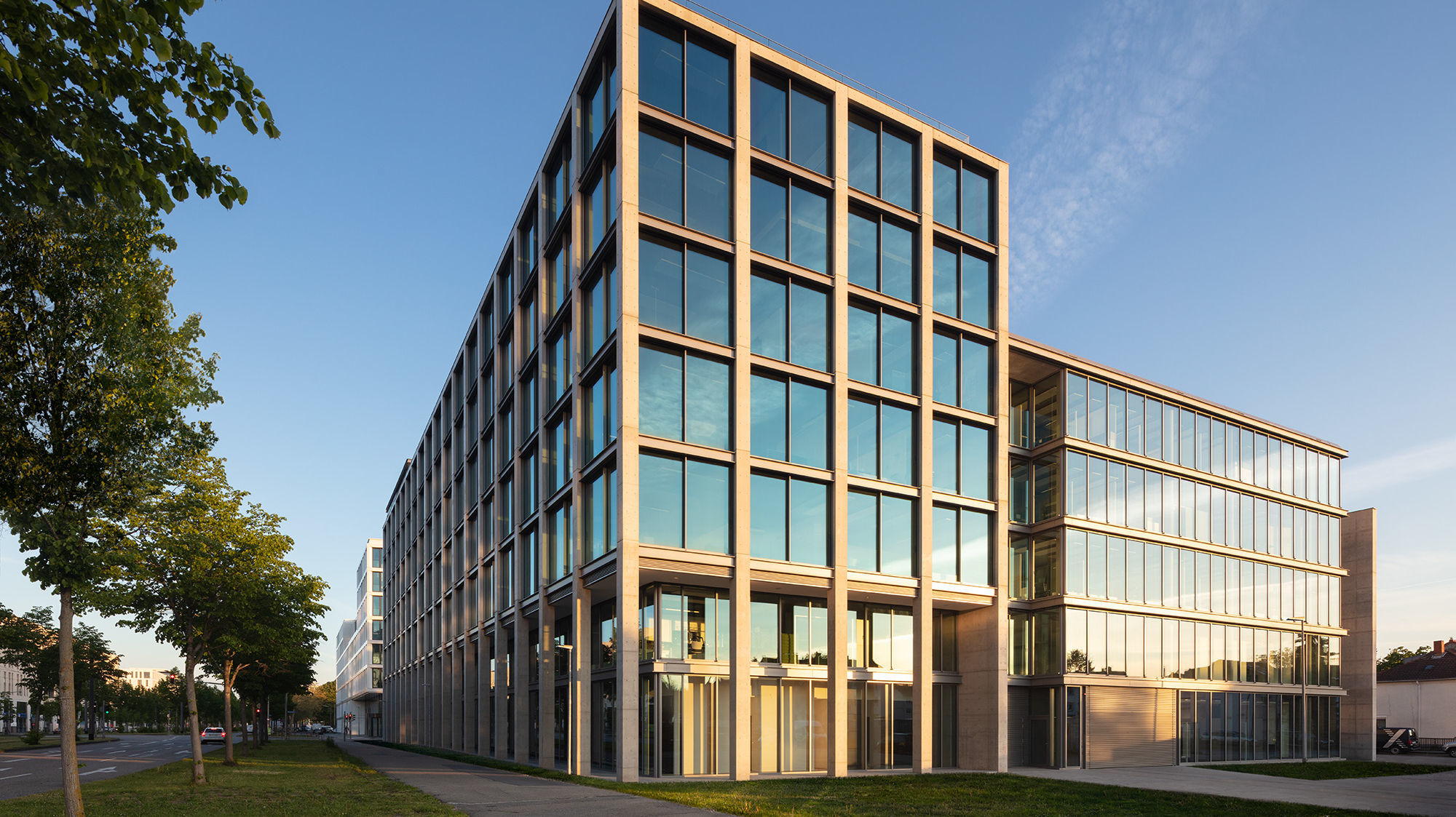 The east facade of the building is lighted up by the last sunrays of the day