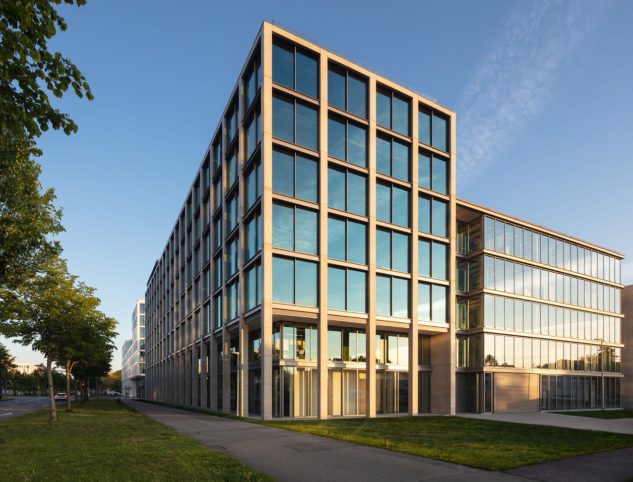 The east facade of the building is lighted up by the last sunrays of the day