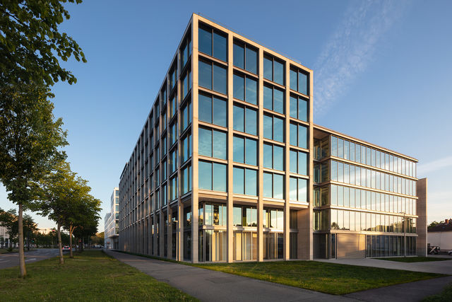 The east facade of the building is lighted up by the last sunrays of the day