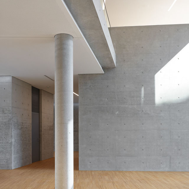 Concrete column and concrete wall with anchor holes in the foyer of the weisenburger headquarter.