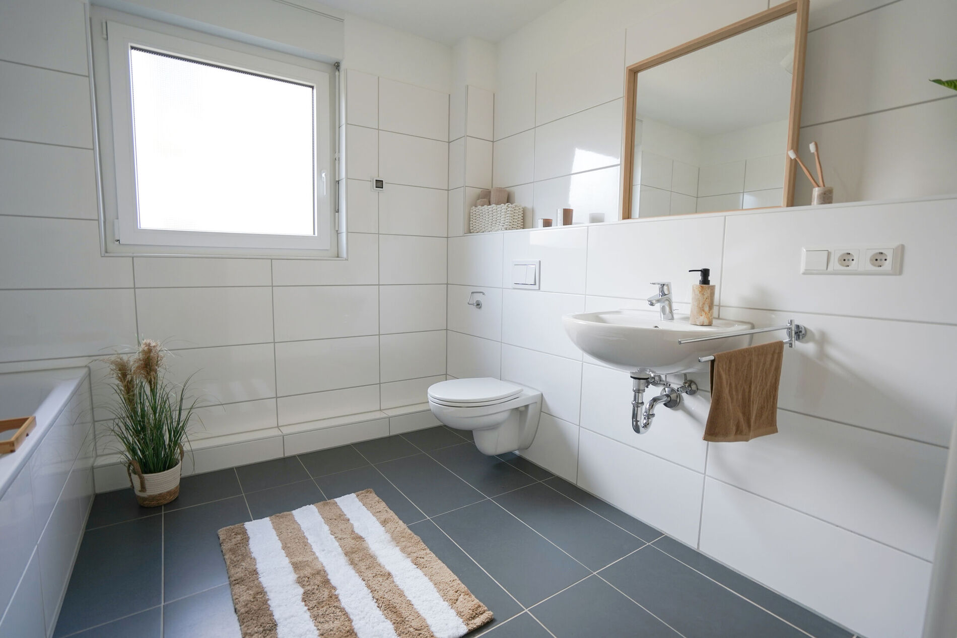 Badezimmer mit Toilette, Waschbecken und Badewanne