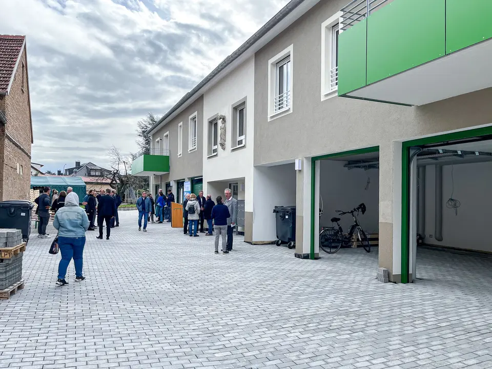 Key handover of an apartment building with gray paint and green balconies