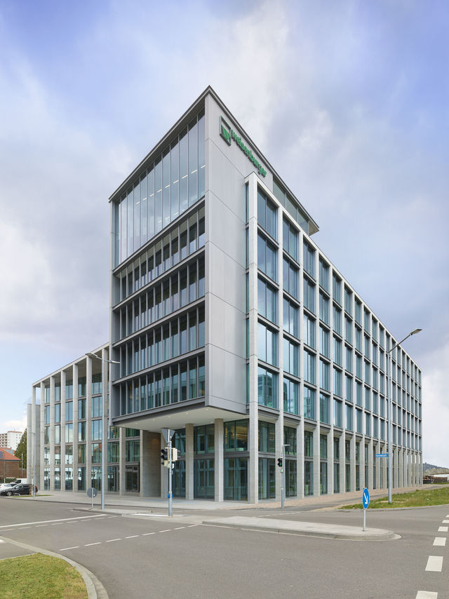 View from southwest corner of the glass and concrete building.