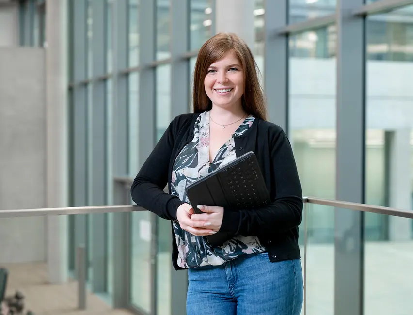 Friendly weisenburger sales employee with tablet in modern office building
