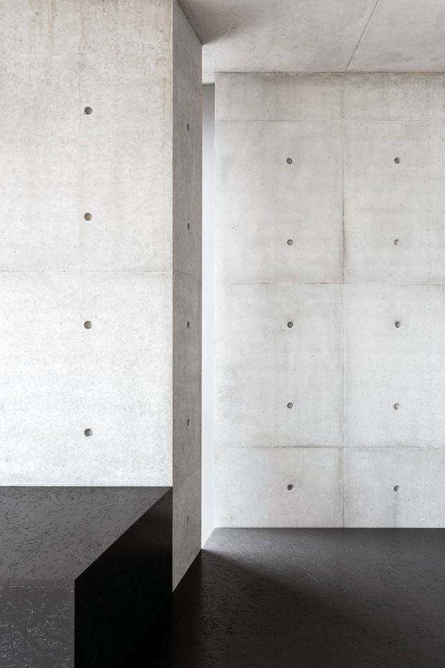Offset exposed concrete wall with anchor holes