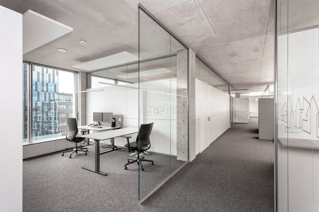 Bright, semi-open office with a glass wall